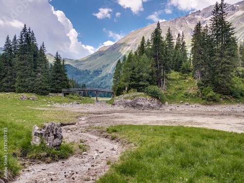 Dried-up lake Obernberger See in the Tyrolean alps in July. Obernberg am Brenner, Tyrol, Austria photo