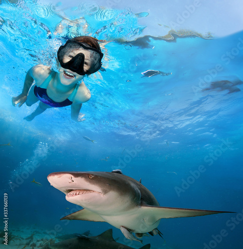 Young girl swimming with sharks.