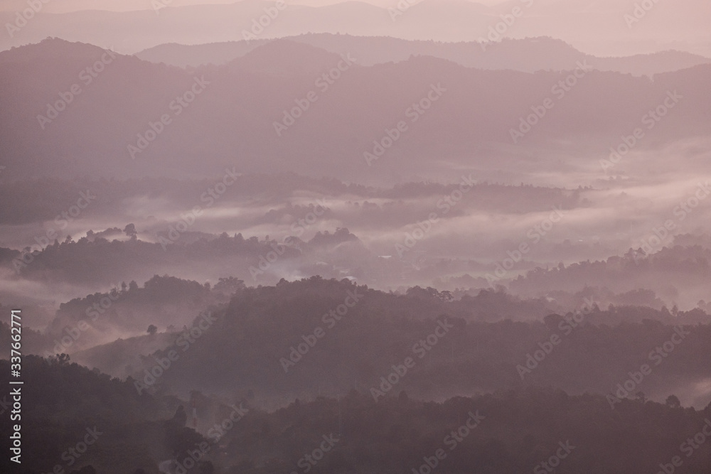 Twilight, sunrise and sea of fog in the morning on the mountains of northern Thailand, during the rainy season.