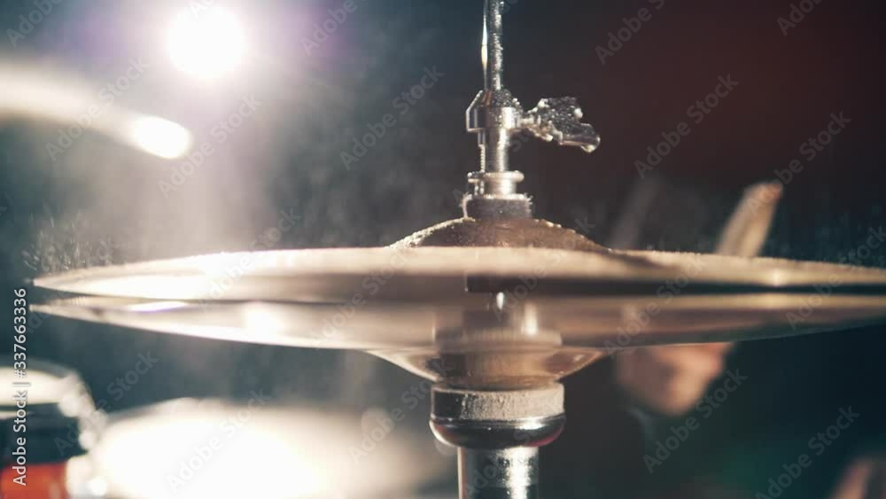 Drummer, drumset, drums in slow motion Metal drum cymbals with water.