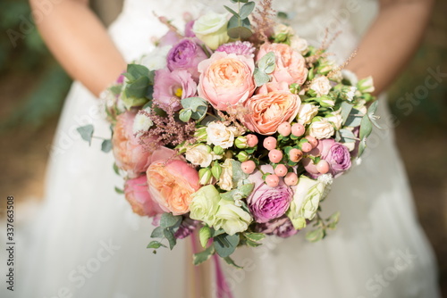 Bridal bouquet of roses, eustoma and ornamental plants

