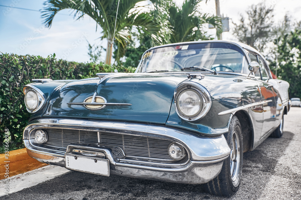 beautiful retro cars, palm trees and clouds