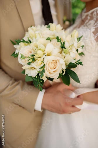 Bridal bouquet of roses, eustoma and ornamental plants 