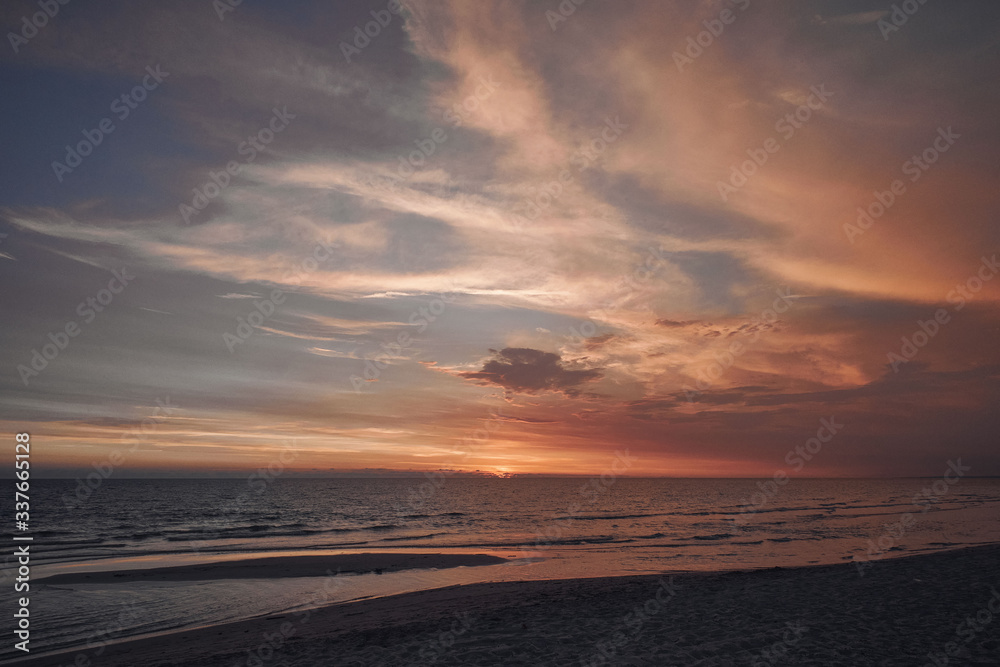 Stunning colorful sunset on a sandy beach.