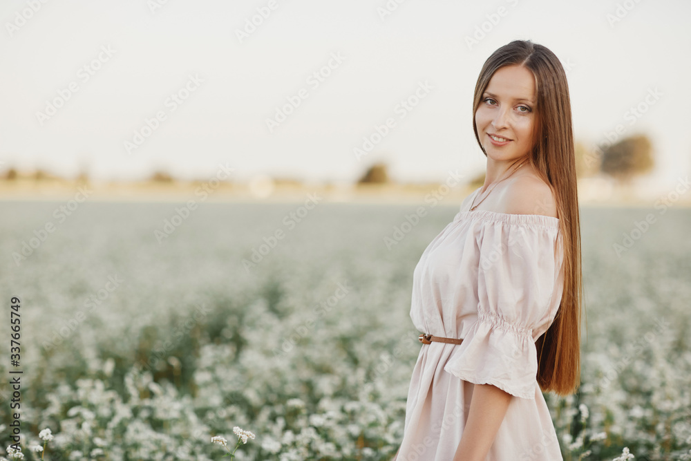 Beautiful woman enjoying field, happy young lady and spring green nature, harmony concept. portrait of a beautiful girl in a field of flowers. selective focus Beautiful woman enjoying field, happy young lady and spring green nature, harmony concept. portrait of a beautiful girl in a field of flowers. selective focus