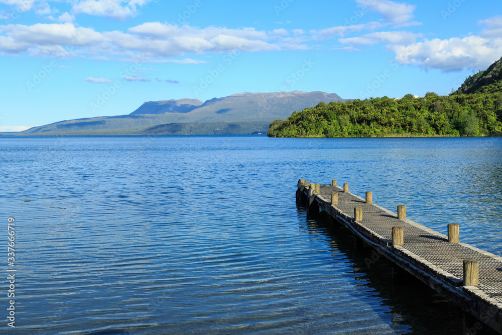 Beautiful Lake Tarawera in the Rotorua area, New Zealand. In the background are the slopes of volcanic Mount Tarawera