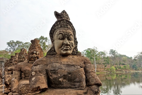Cambodia. The temple complex of Angkor. Ancient statues with mysterious smiles on their faces look at us.