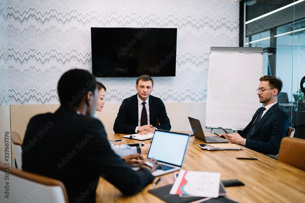 Young businesspeople brainstorming project plan in office