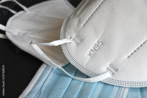 Detail of white medical mask FFP2 KN95 with antiviral medical mask for protection against coronavirus. Surgical protective mask. prevention of the spread of virus and pandemic COVID-19. photo