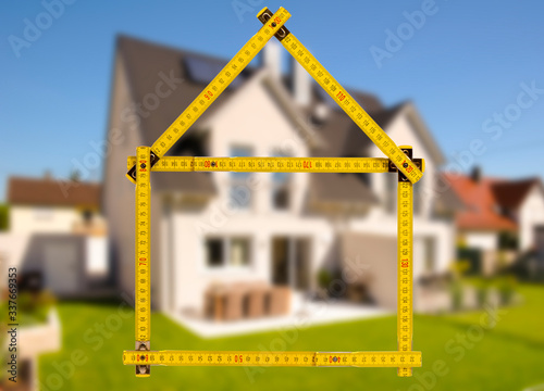 newly built house with a yardstick photo