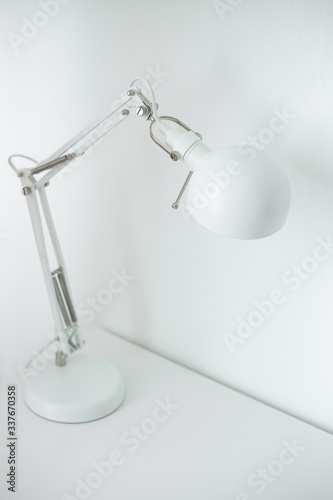 White desk lamp on white table