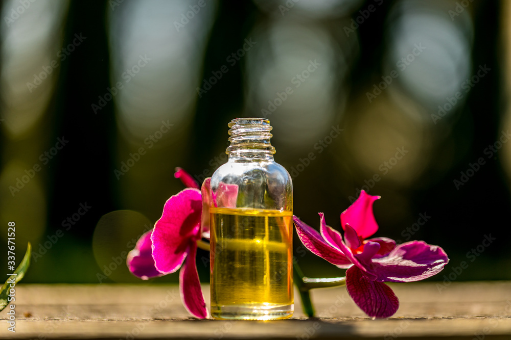 Spa still life with essential oils and orchid on bokeh background. Spa still life with essential oils and orchid on bokeh background.