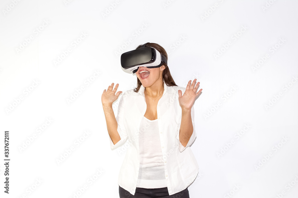 Beautiful girl uses Virtual Reality a helmet with surprise and enthusiasm Beautiful girl uses Virtual Reality a helmet with surprise and enthusiasm