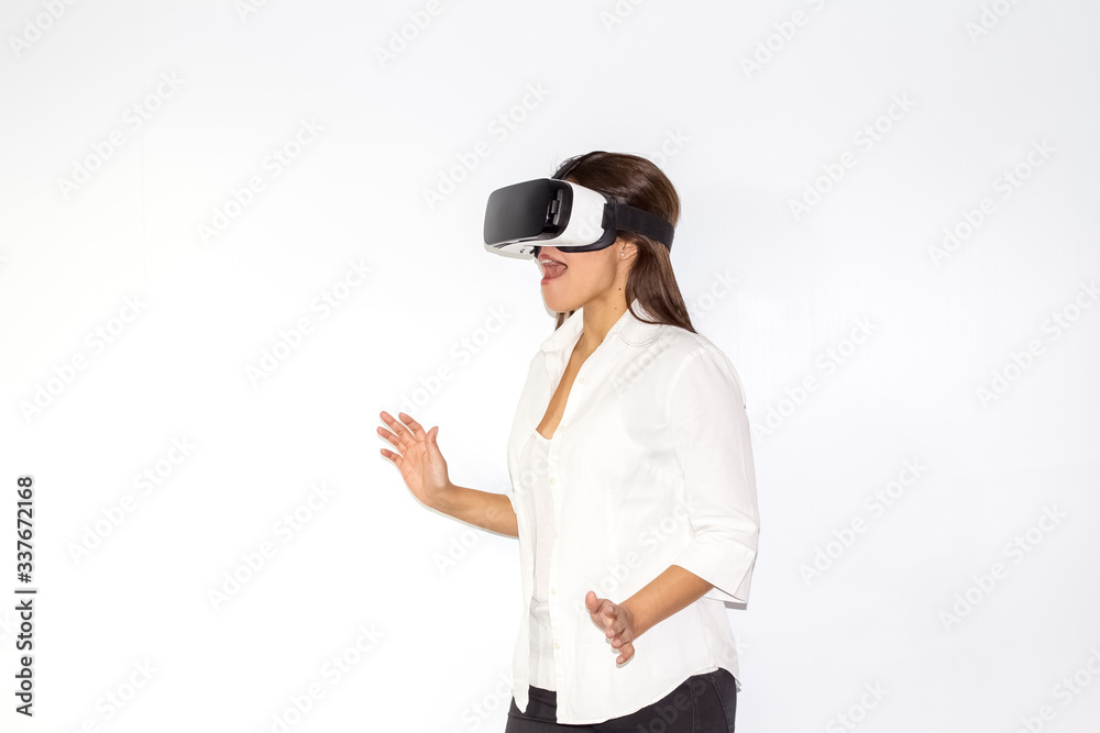 Beautiful girl uses Virtual Reality a helmet with surprise and enthusiasm Beautiful girl uses Virtual Reality a helmet with surprise and enthusiasm
