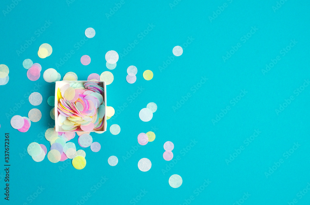 Turquoise festive background with confetti.