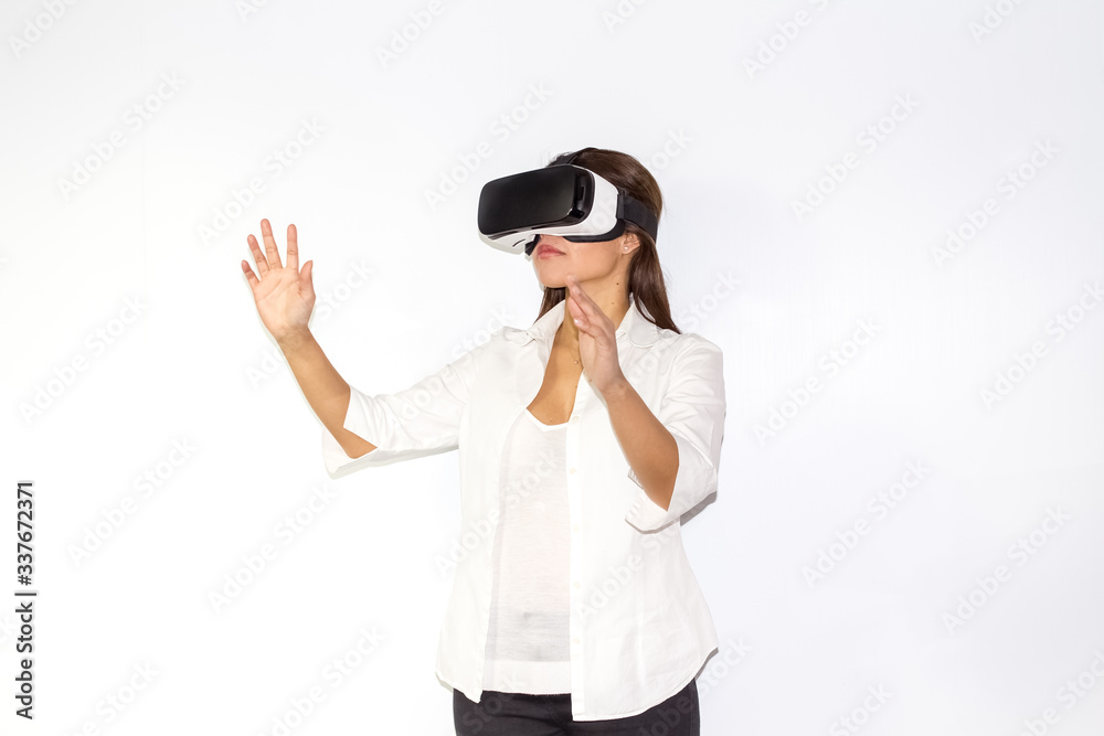 Beautiful Girl tries VR headset on white background Beautiful Girl tries VR headset on white background