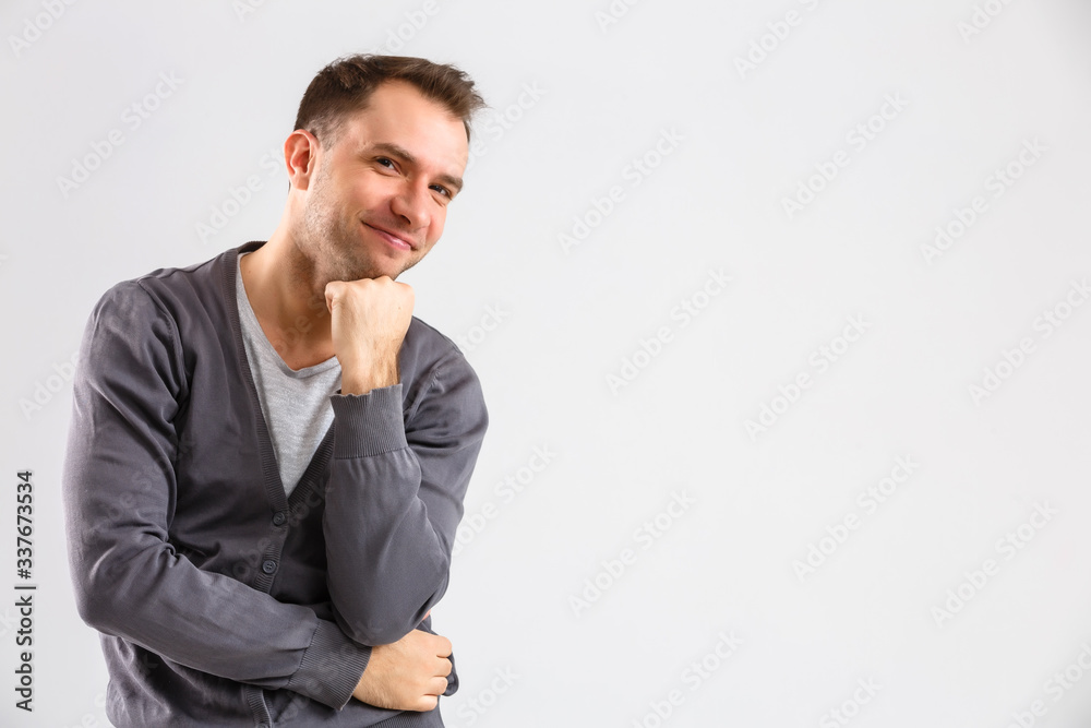portrait emotional man standing near a wall on a gray background