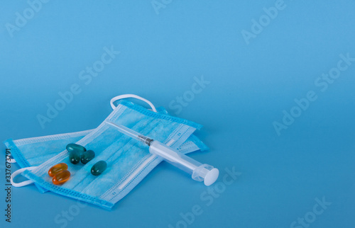 Protective masks to be used by medical and non-medical staff during an emergency situation. Syringe for injection.