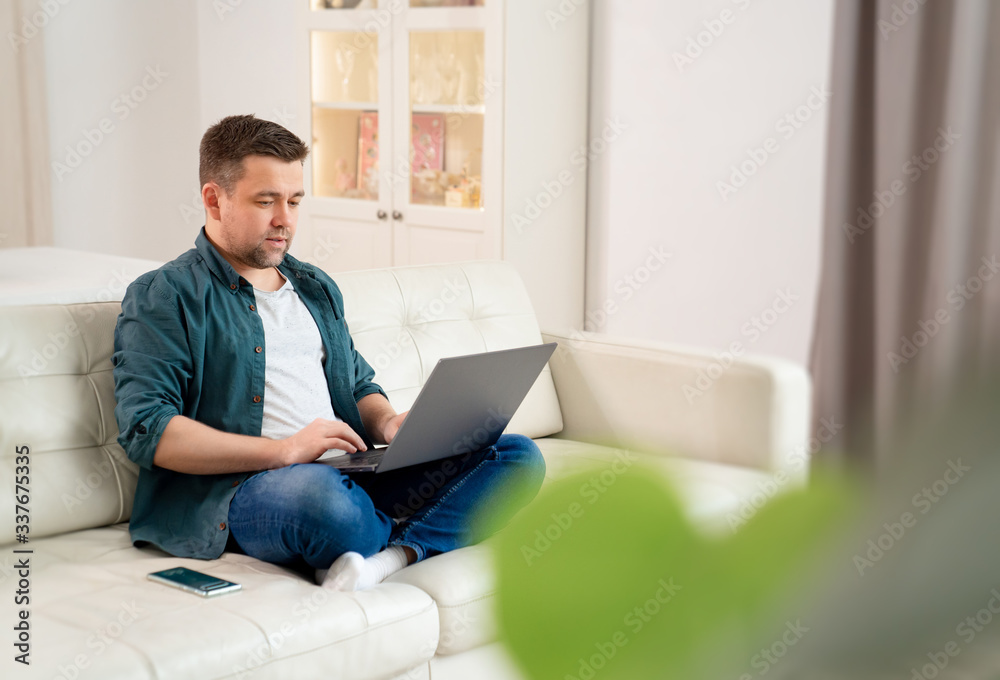 freelancer working online sitting on the couch. freelancer working online sitting on the couch.