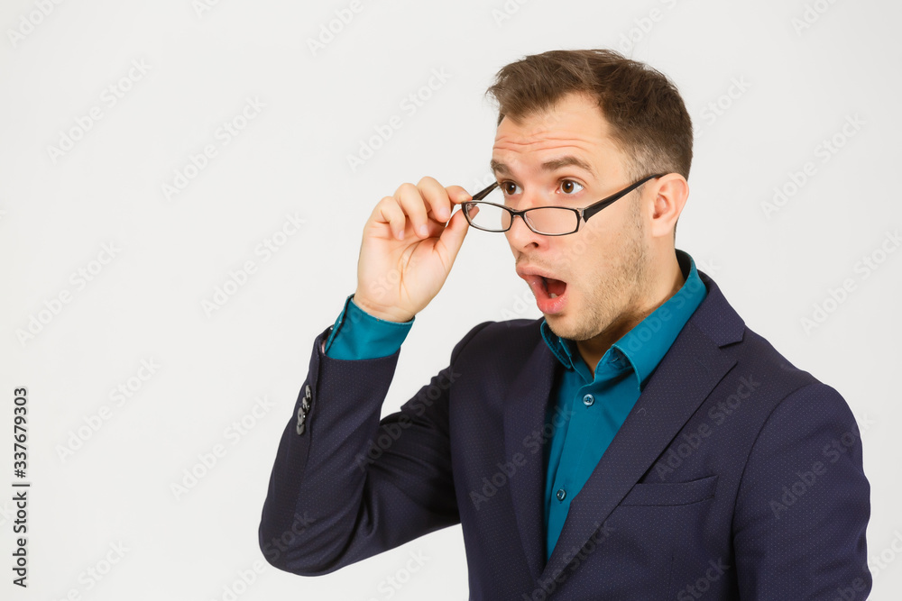 A view of a shocked young businessman isolated on white background A view of a shocked young businessman isolated on white background