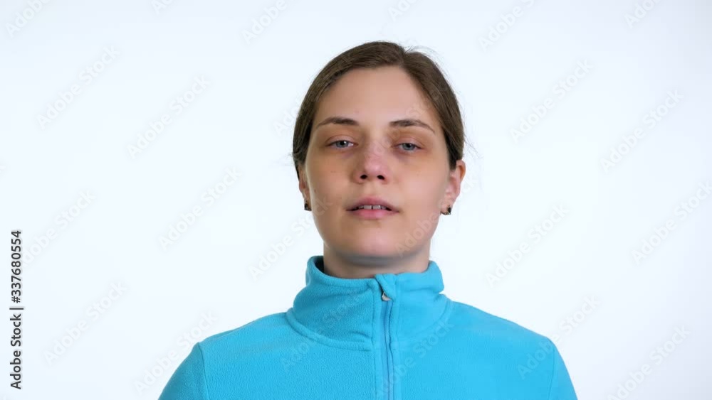 Young woman takes off medical mask. Female breathes deeply and looking at camera. Isolated on white background. Coronavirus pandemic epidemic is over. End of quarantine and self-isolation. Young woman takes off medical mask. Female breathes deeply and looking at camera. Isolated on white background. Coronavirus pandemic epidemic is over. End of quarantine and self-isolation.