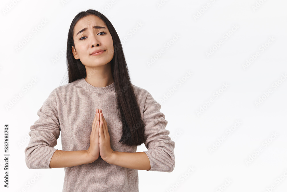 Girl really need your help, asking for offer. Attractive uneasy young east-asian modern woman with dark hair, press palms together near chest in pray, begging, lending money, look with need Girl really need your help, asking for offer. Attractive uneasy young east-asian modern woman with dark hair, press palms together near chest in pray, begging, lending money, look with need