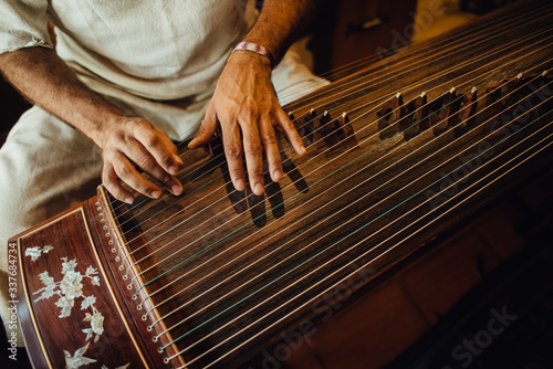 Hands of a musician playing guzheng, Chinese musical instrument photo