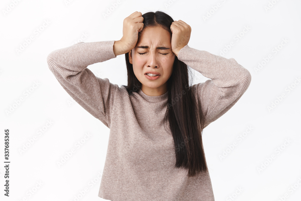 Depression, anxiety or problems concept. Troubled asian girl cant understand what happening, need help, suffering emotional breakdown, close eyes and grab head, crying feeling distressed and upset Depression, anxiety or problems concept. Troubled asian girl cant understand what happening, need help, suffering emotional breakdown, close eyes and grab head, crying feeling distressed and upset