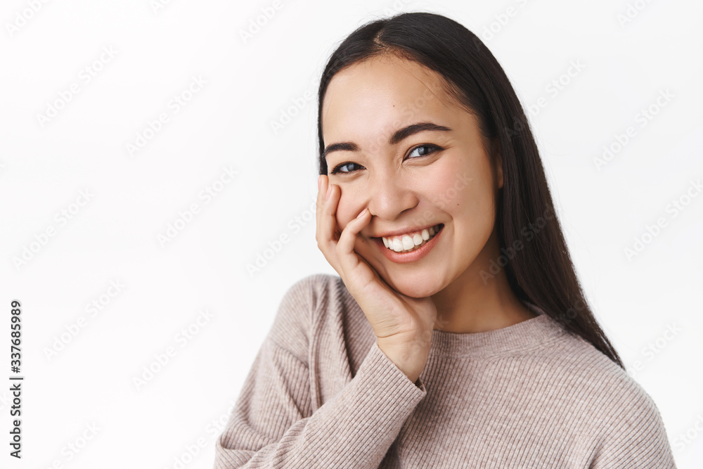 Happiness, people and skincare concept. Cheerful tender and romantic young silly asian woman with long dark straight haircut, touching cheek and giggle as flirting or blushing from nice compliment Happiness, people and skincare concept. Cheerful tender and romantic young silly asian woman with long dark straight haircut, touching cheek and giggle as flirting or blushing from nice compliment