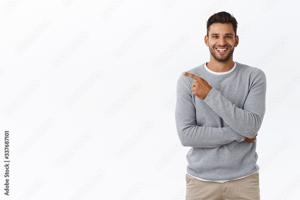 Man praising great concept, pointing left at your project as discuss corporate staff coworker. Attractive pleased businessman in grey casual sweater having chat and recommend check-out product Man praising great concept, pointing left at your project as discuss corporate staff coworker. Attractive pleased businessman in grey casual sweater having chat and recommend check-out product
