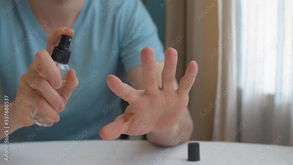 man disinfecting hand man disinfecting hand