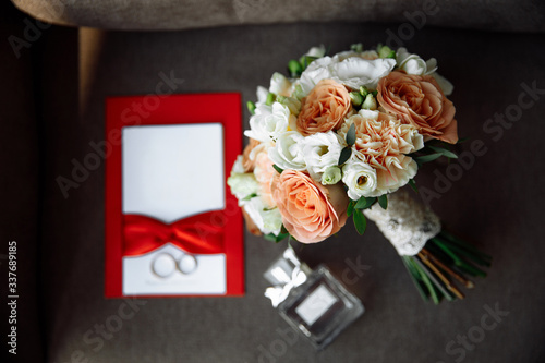 Elements of wedding decor. Wedding rings, perfume, wedding bouquet, greeting card, invitation. Top view, flat lay