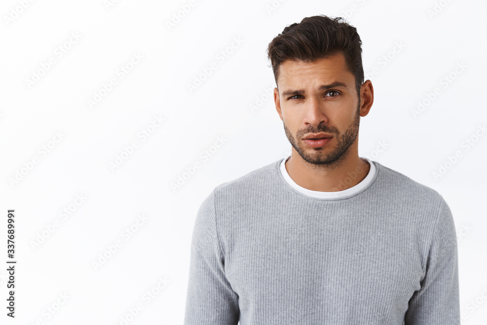 You talking to me. Arrogant and skeptical good-looking bearded macho guy in grey sweater, looking disbelief and questioned expression, raise eyebrow arched hesitant, doubtful about offer You talking to me. Arrogant and skeptical good-looking bearded macho guy in grey sweater, looking disbelief and questioned expression, raise eyebrow arched hesitant, doubtful about offer