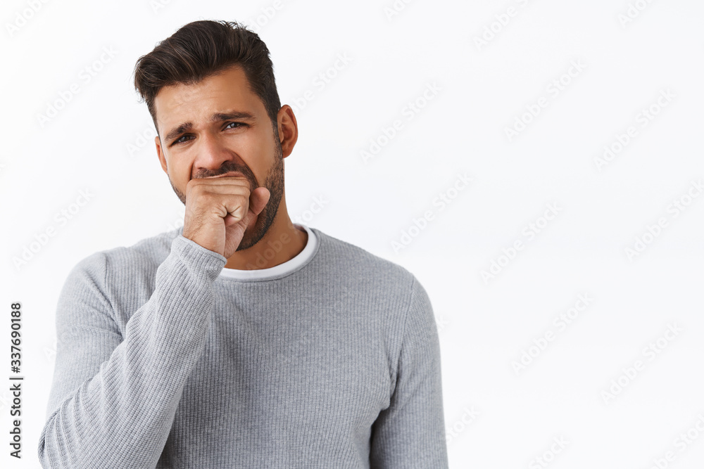 Handsome guy being bored talking with stranger about random staff, yawning cover opened mouth with fist, squinting tired, standing with fatigue look, dont like boring events, white background Handsome guy being bored talking with stranger about random staff, yawning cover opened mouth with fist, squinting tired, standing with fatigue look, dont like boring events, white background