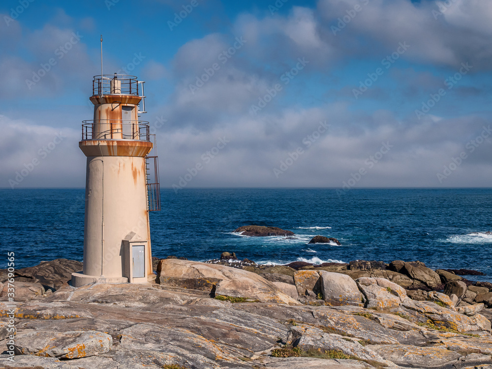 Lighthouse at Punta da Barca, next to the Sanctuary of Virxe da Barca in Muxia, Galicia, Spain