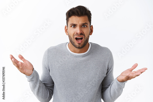 Clueless disappointed angry male client shocked with bad service, spread hands sideways in dismay and distressed, arguing looking questioned and frustrated, complain or condone someone