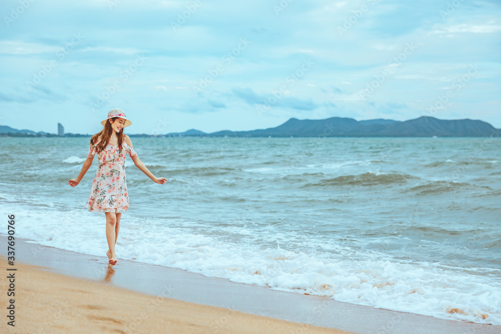 Travel woman walking on beach