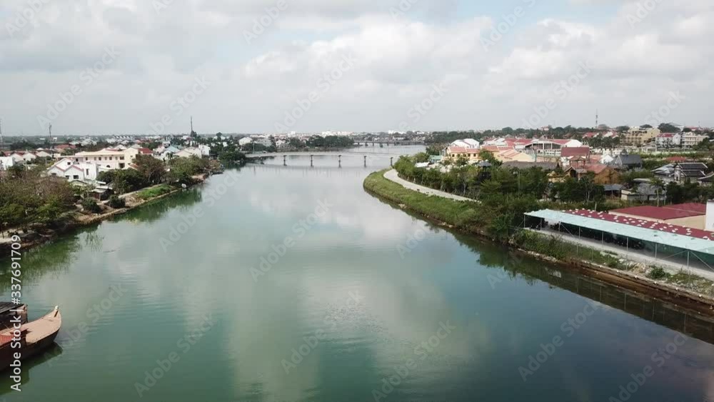 a flying camera takes off the brown roofs of houses in Hoi An against the of no roads, people, boats, a river. a flying camera takes off the brown roofs of houses in Hoi An against the of no roads, people, boats, a river.