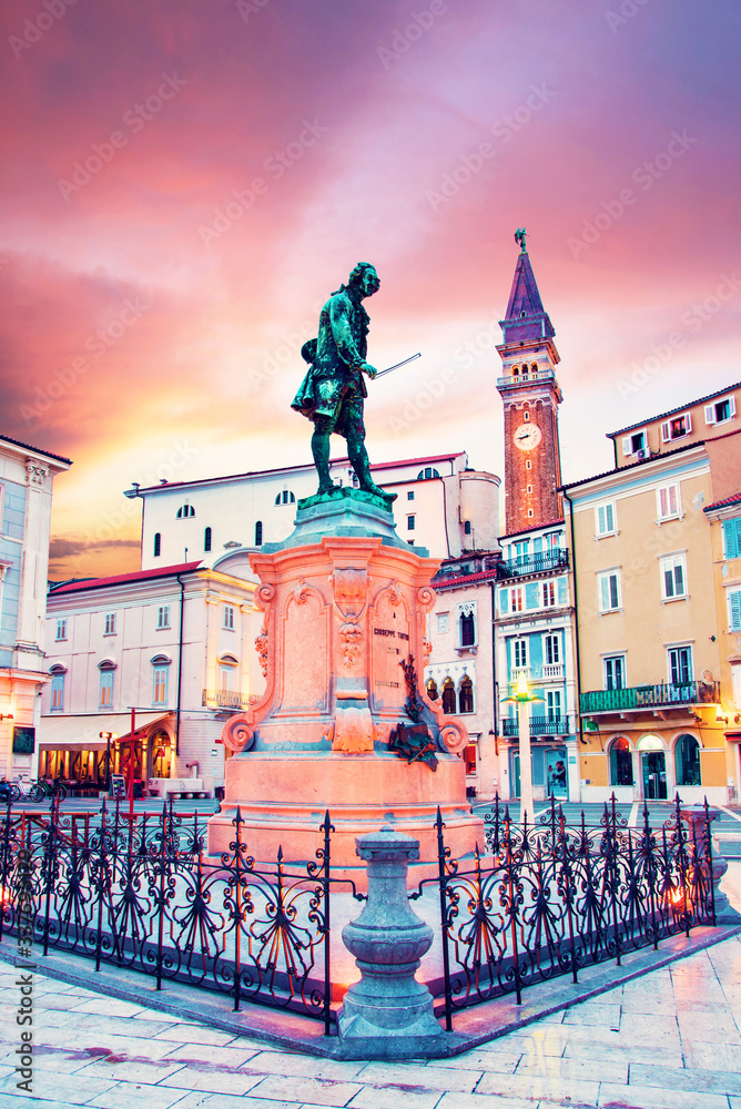 Beautiful amazing city scenery with the monument the famous Italian violinist and composer Giuseppe Tartini in the central square in Piran, the tourist center of Slovenia. popular tourist attraction
