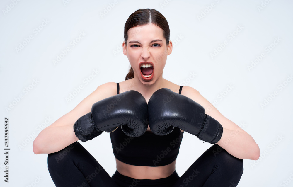 Young sports girl with boxing gloves on a white background. Young sports girl with boxing gloves on a white background.