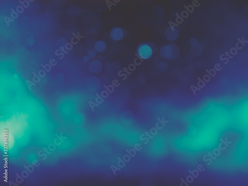 Bokeh light abstract vintage blue color blurred on black background. Sparkling magical dust particles.