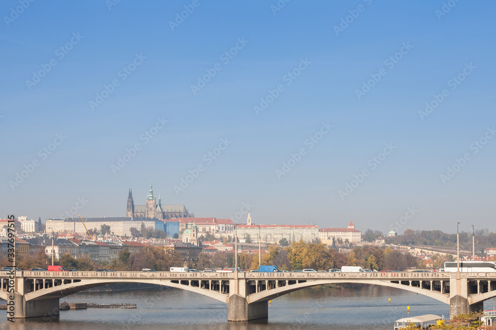 Panorama of the Old Town of Prague, Czech Republic, with a focus on Jiraskuv Most bridge and the Prague Castle (Hrad Praha) seen from the Vltava river. The castle is the main touristic landmark
