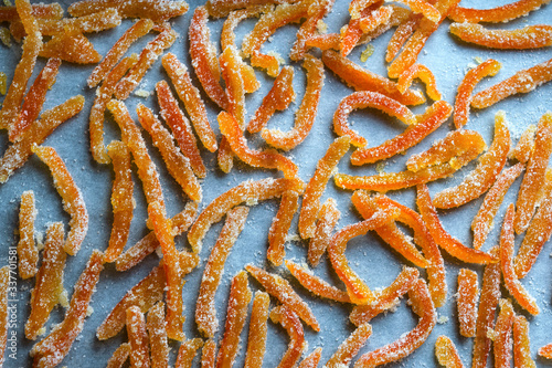 Stripes of orange peels in sugar. Candied fruits. View over.
