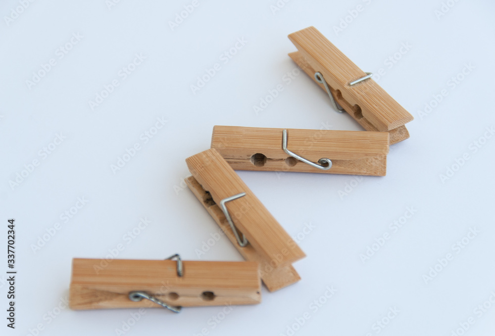 Wooden clothes pins in a zig zag shape. Isolated on a white background. Close up