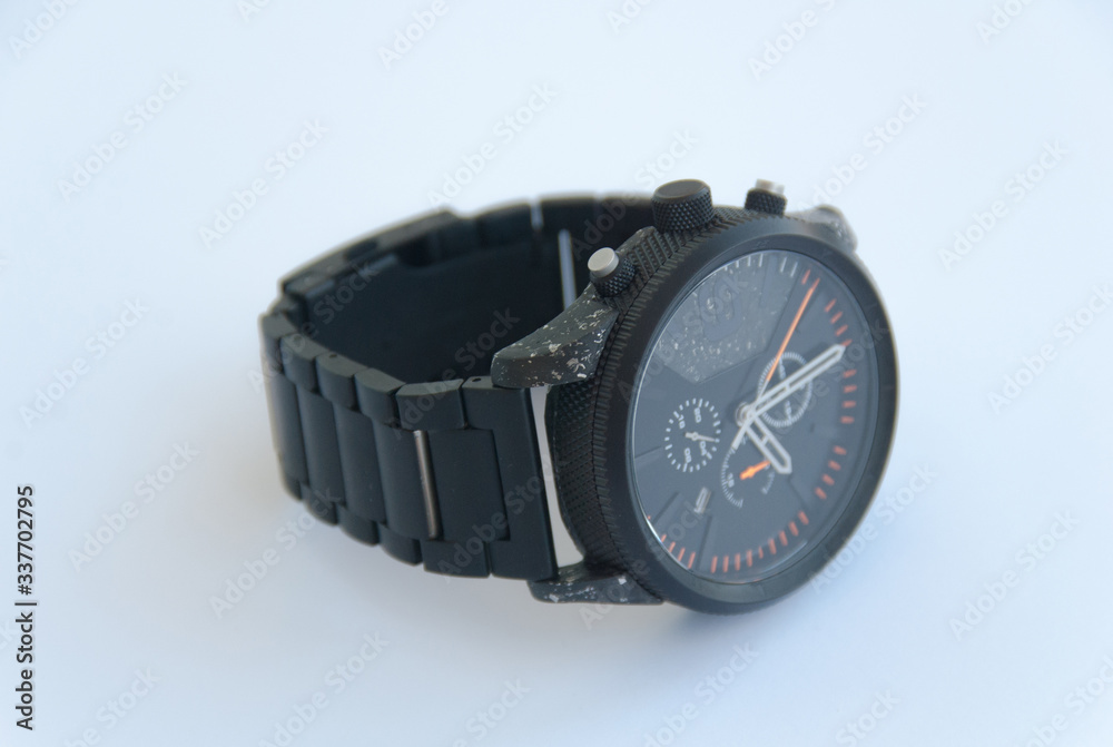 Men black metal watch lying on white background. Isolated. Close up Men black metal watch lying on white background. Isolated. Close up