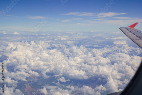 Beautiful Clouds of Vertical Development, Stratocumulus, Cumulus sky on the top view, airplane flying view from inside window aircraft of Traveling.