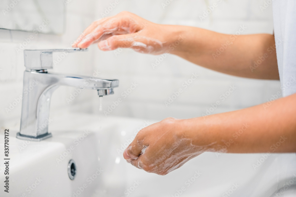 Woman Washing hands to prevent spread of CoronaVirus as well as cold, flu, bacteria at home Woman Washing hands to prevent spread of CoronaVirus as well as cold, flu, bacteria at home