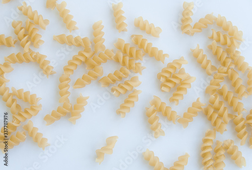 Top view of fusilli swirl italian pasta. Isolated on white background