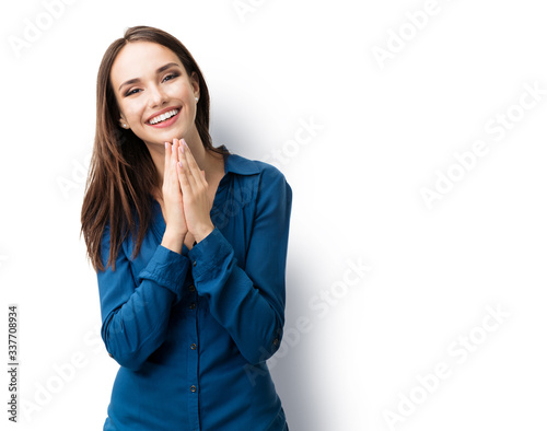 Foto Portrait of happy gesturing smiling brunette lovely woman in casual smart blue clothing, isolated against white background