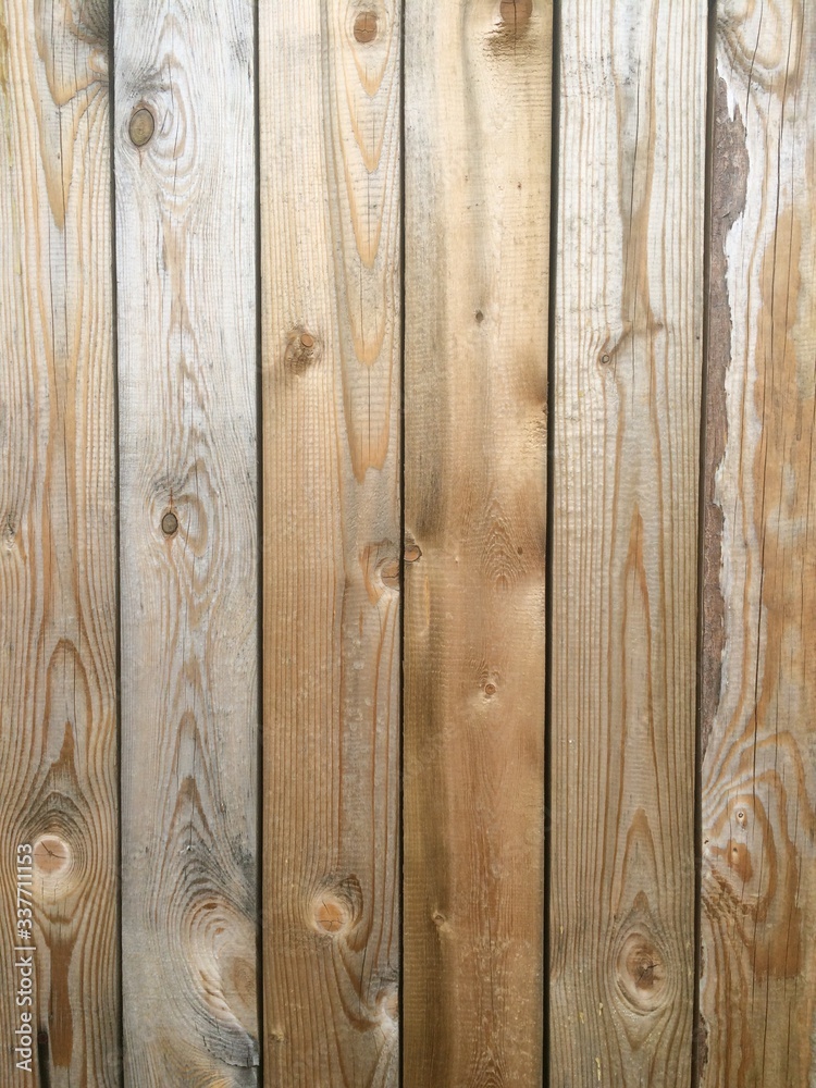 fragment of a wooden surface consisting of panels of different shades of brown fragment of a wooden surface consisting of panels of different shades of brown